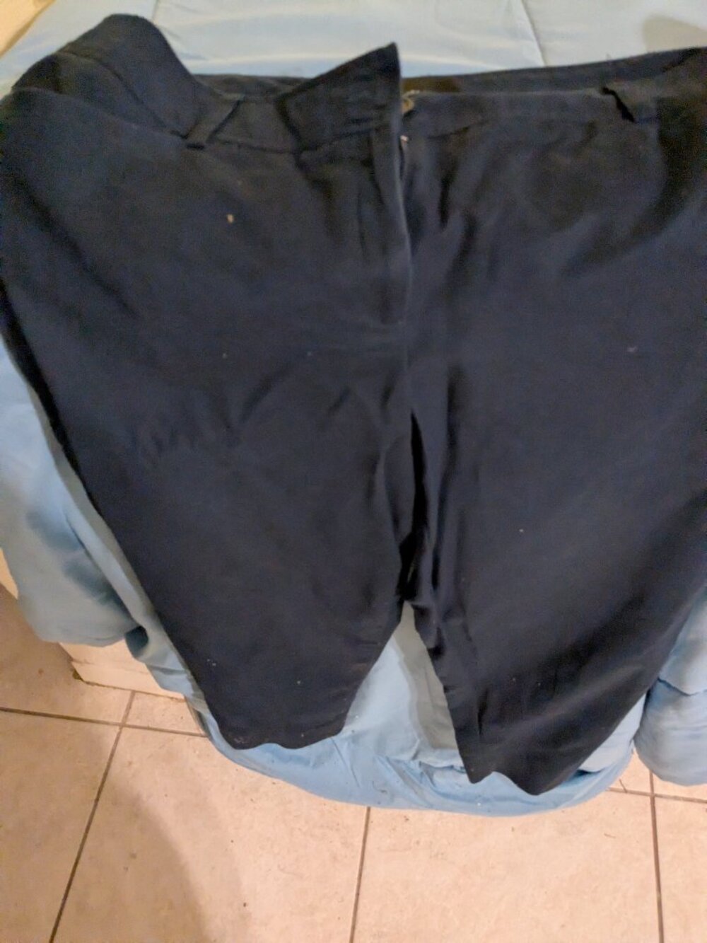 Navy pants with notched ankle.
